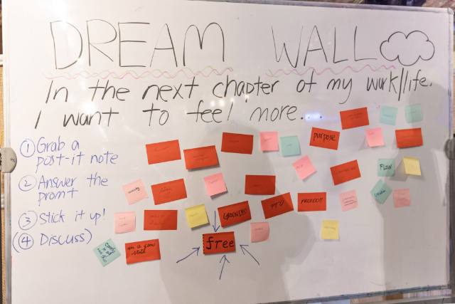 A whiteboard Dream Wall asking what do you want to feel more of in the next chapter of your work/life, covered in colorful sticky notes